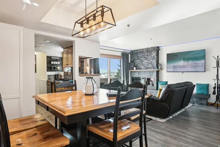 Dining space with light wood-type flooring and a tile fireplace