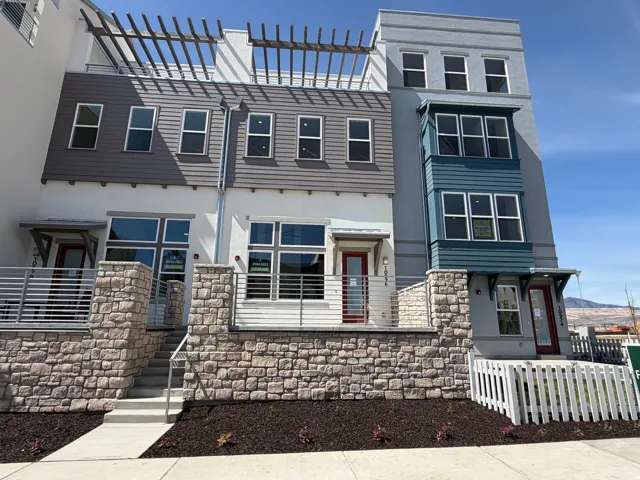 View of front facade featuring stone siding and stucco siding