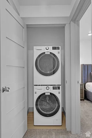 Laundry area featuring stacked washer and clothes dryer