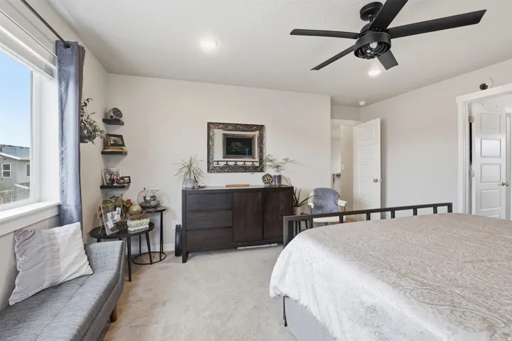 Bedroom featuring light carpet and ceiling fan