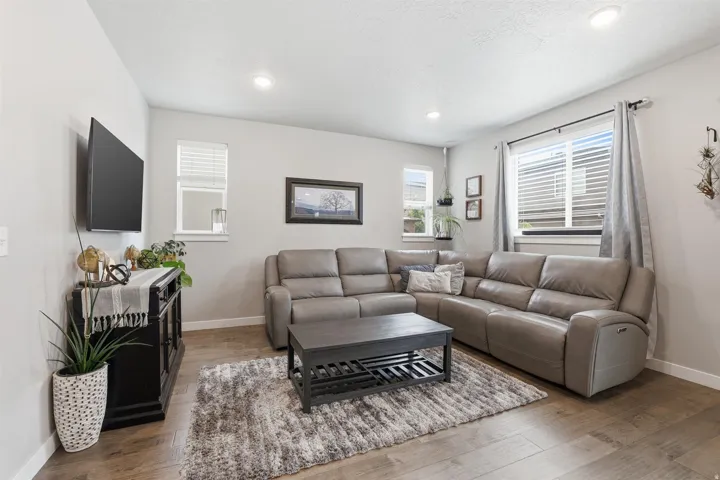 Living area featuring hardwood / wood-style floors and recessed lighting