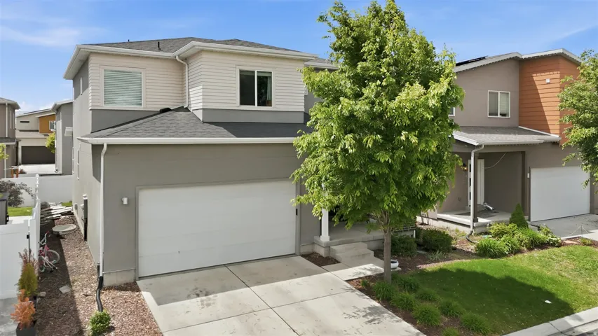 View of front of property with roof with shingles, driveway, covered porch, and stucco siding