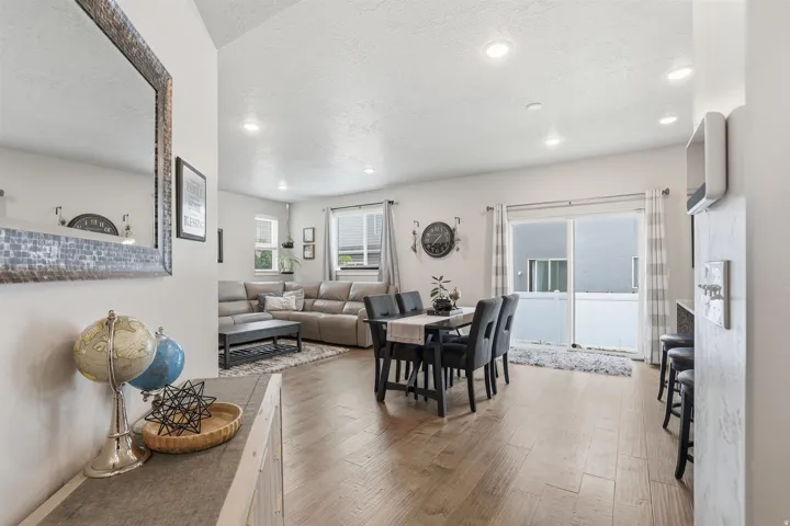 Dining room featuring light wood-type flooring, a textured ceiling, and recessed lighting