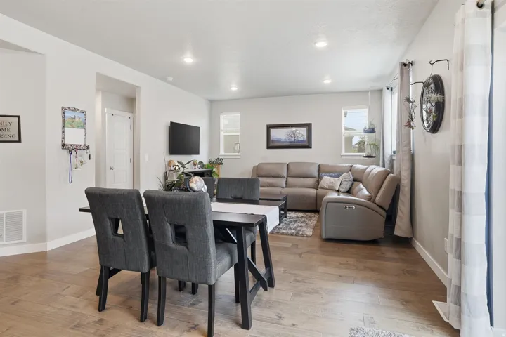 Dining area featuring light wood finished floors and recessed lighting