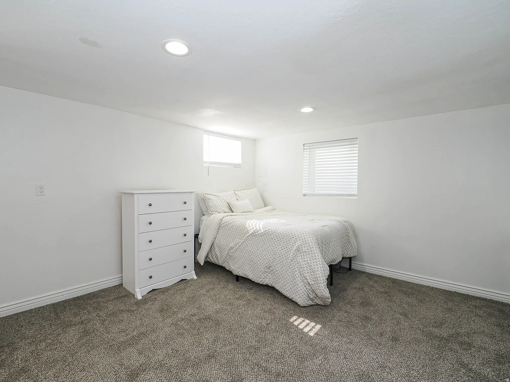 Bedroom with carpet floors and baseboards