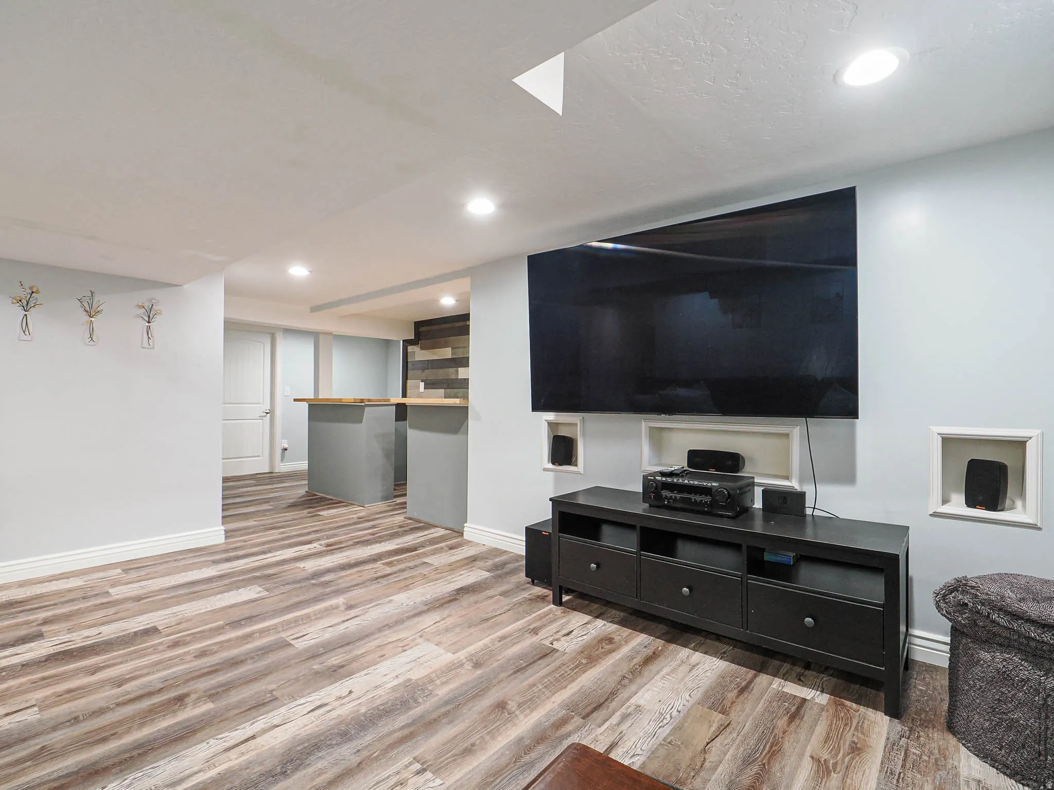 Living room featuring light wood-style flooring and recessed lighting