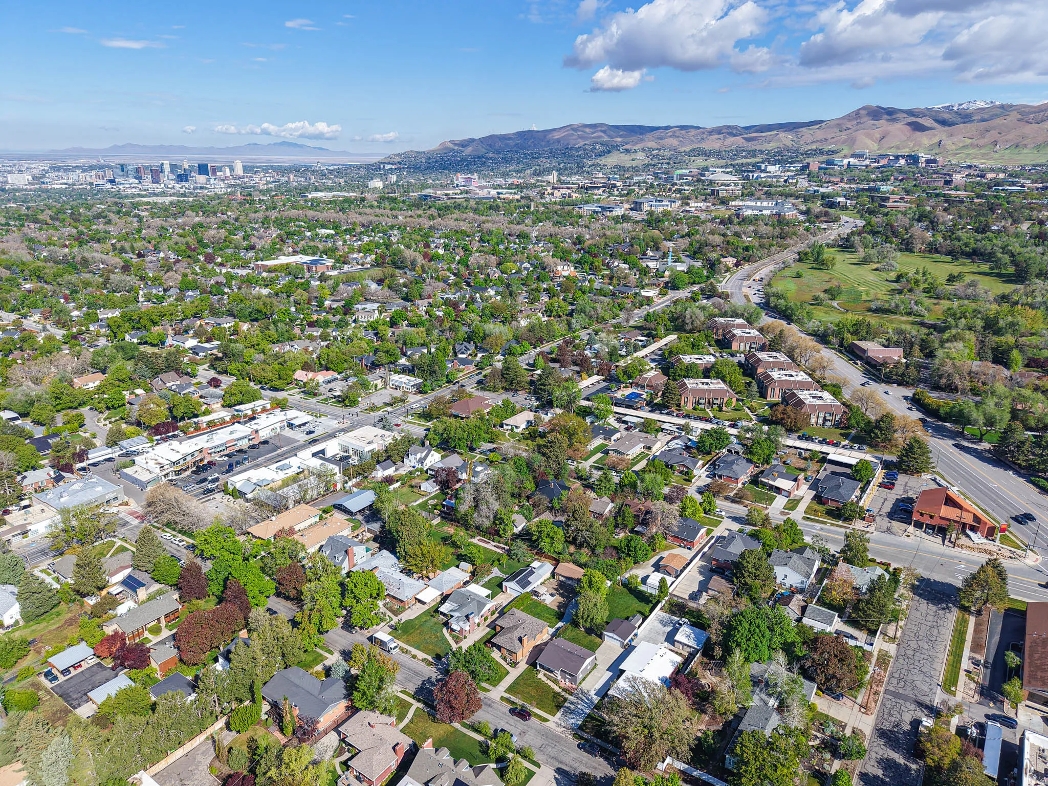 Aerial view of property and surrounding area with a mountainous background