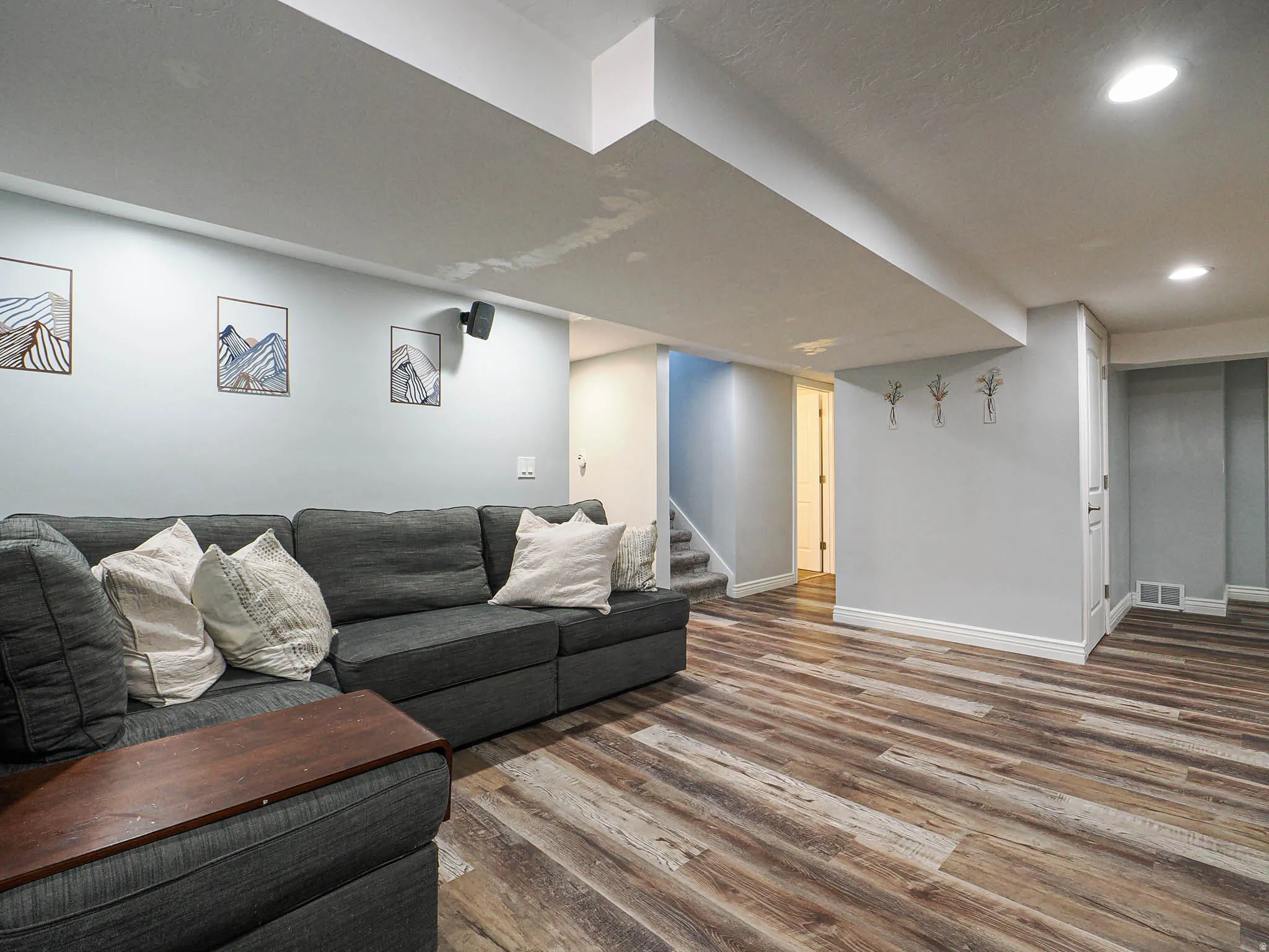 Living room featuring wood finished floors and recessed lighting