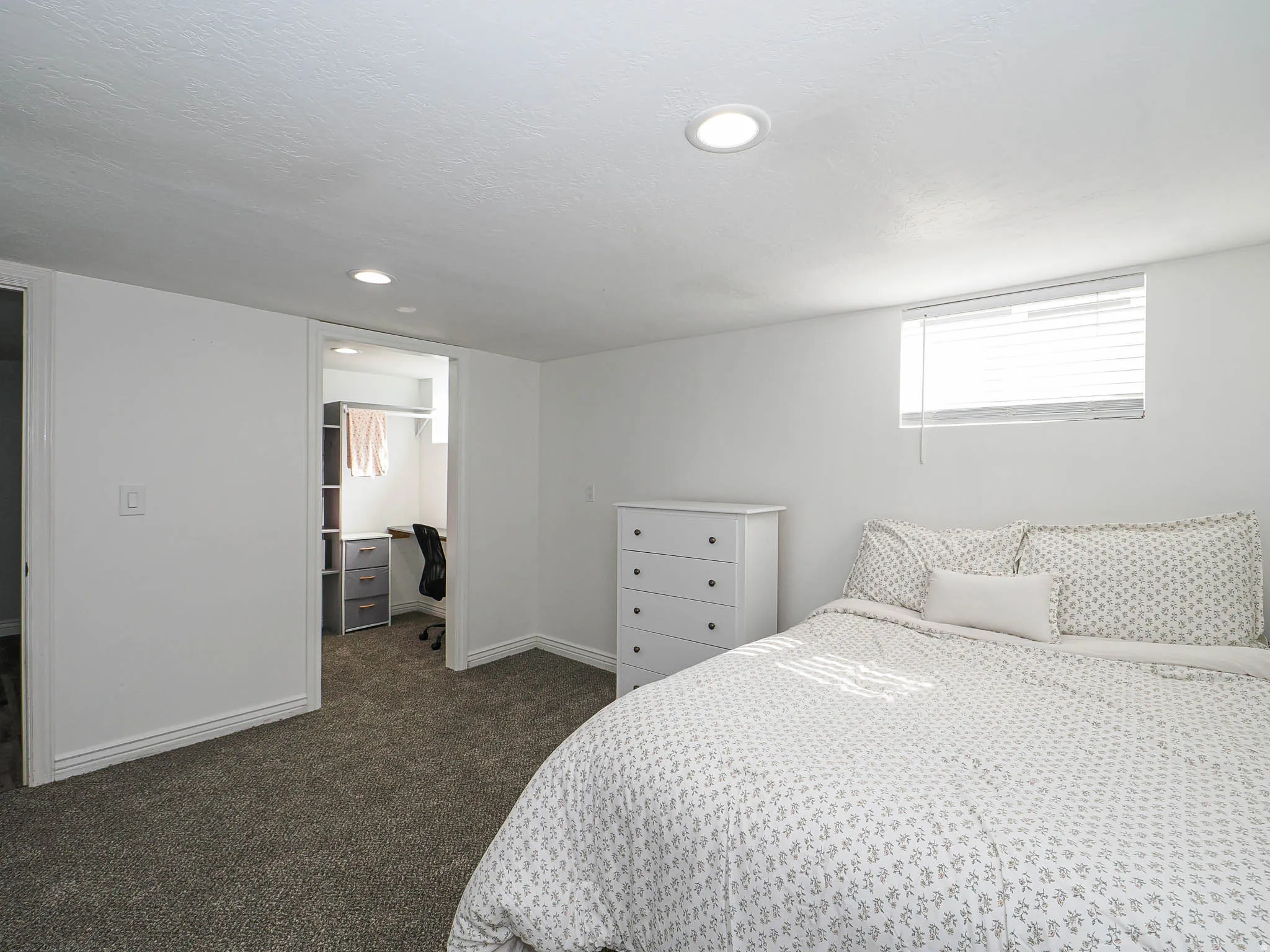 Bedroom with dark carpet, an office area, recessed lighting, and a spacious closet