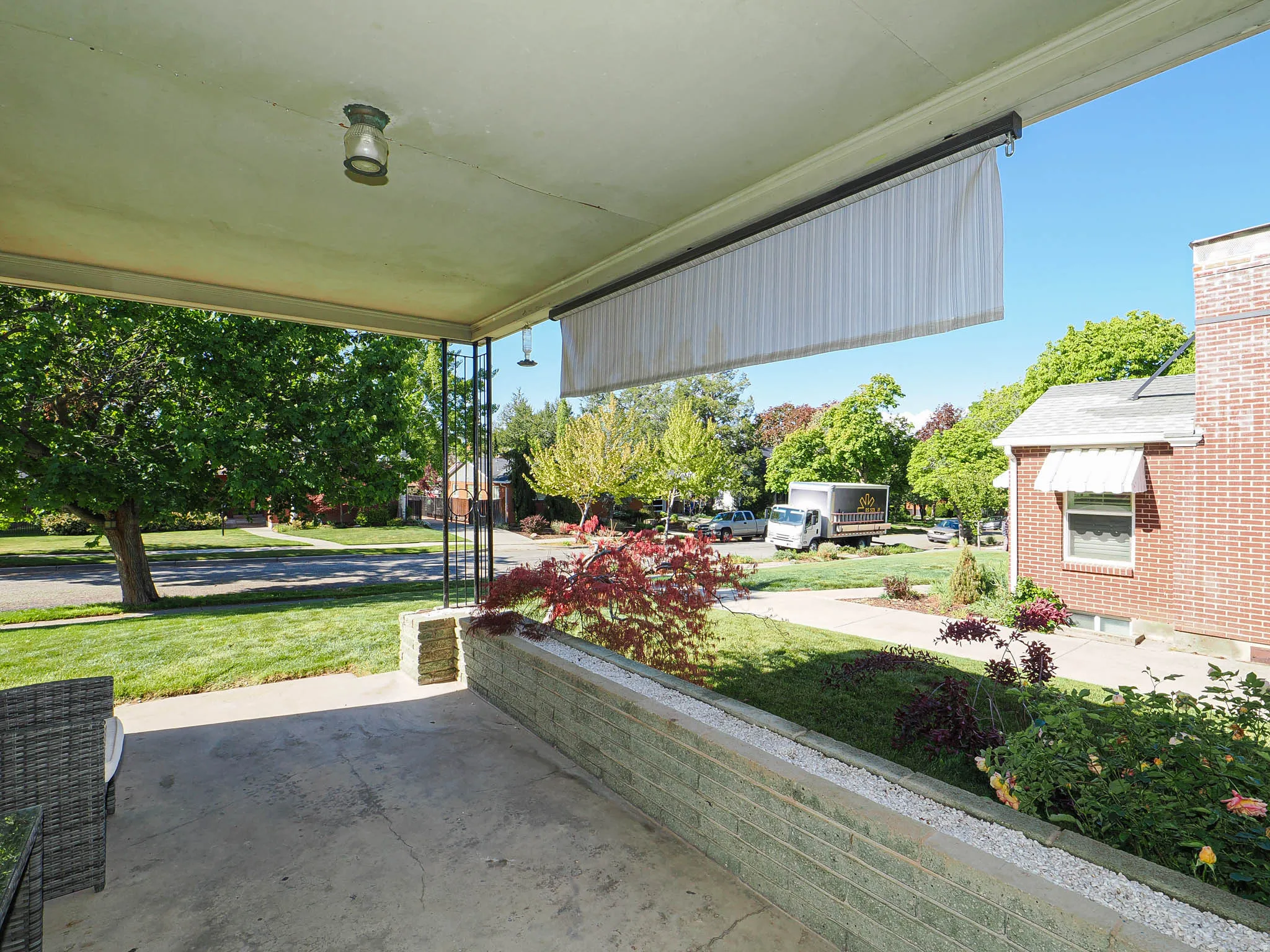 Covered porch featuring a lawn