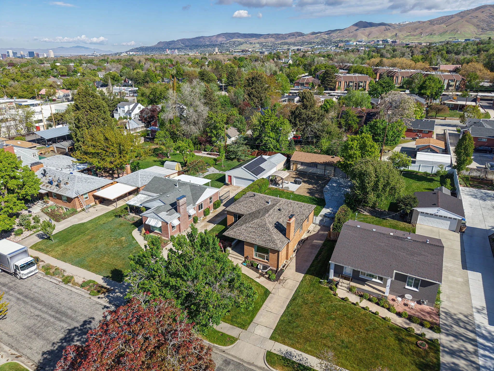 Aerial perspective of suburban area with a mountainous background