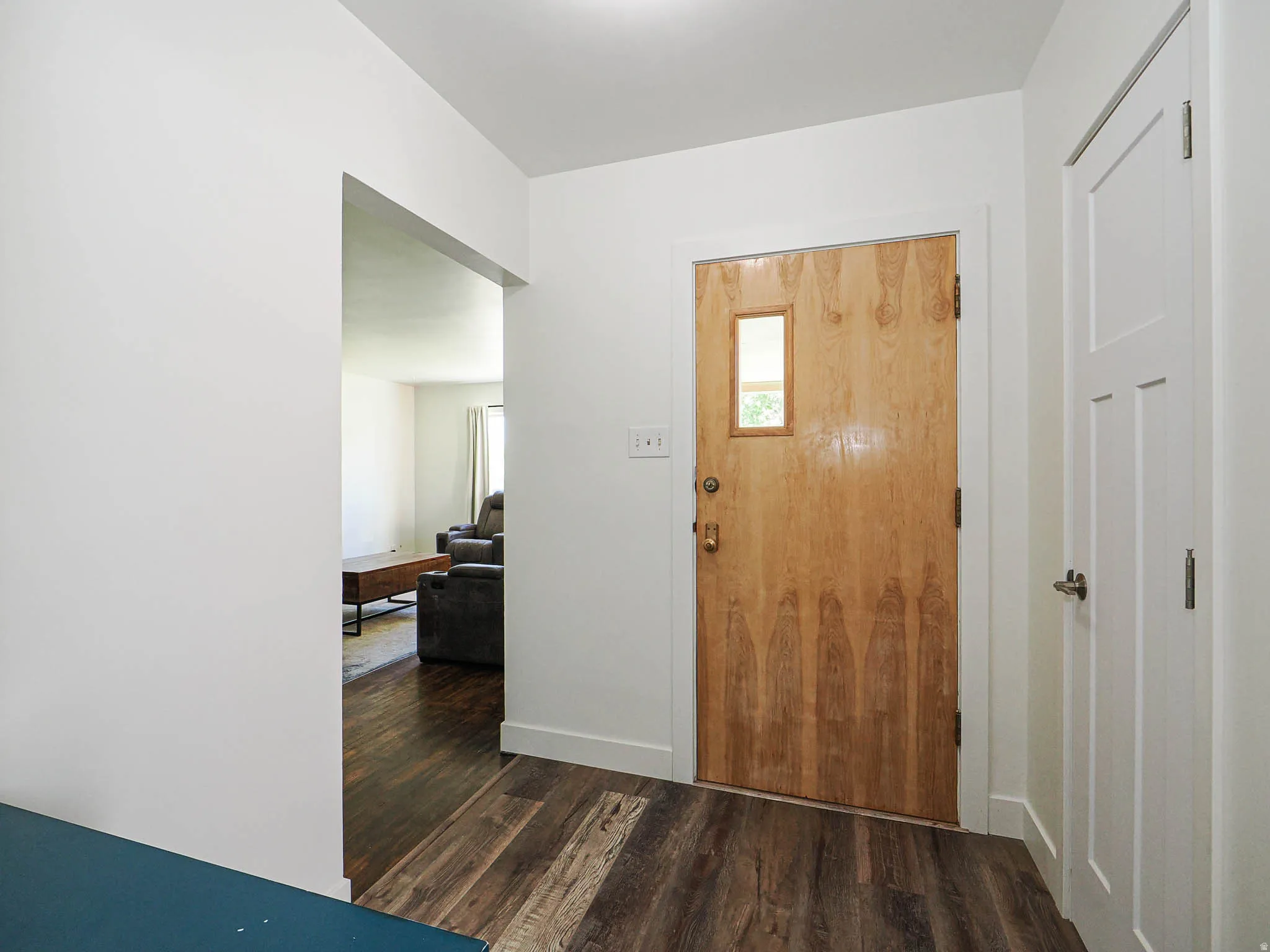 Entrance foyer featuring dark wood finished floors and baseboards