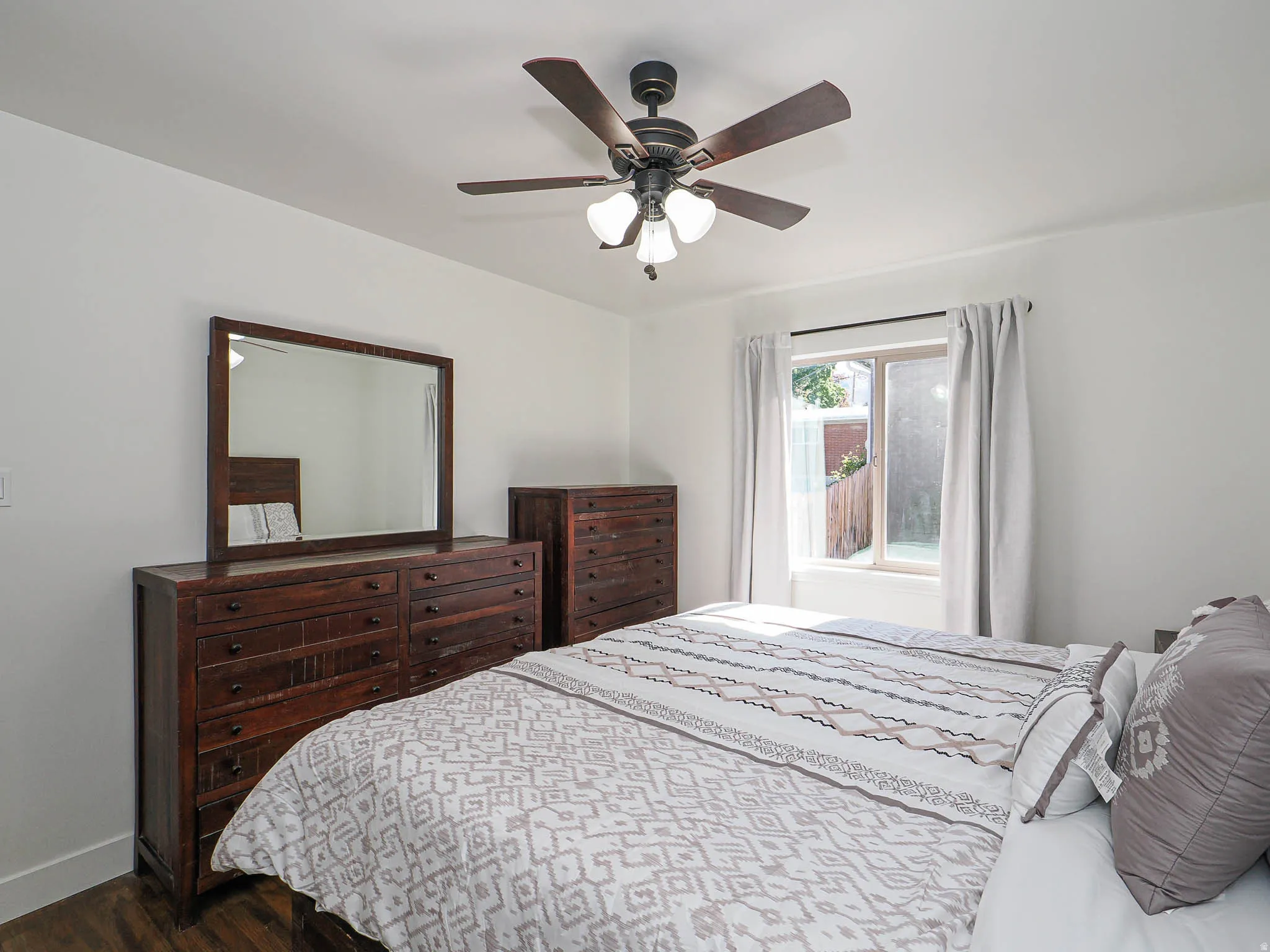 Bedroom featuring dark wood-style floors and ceiling fan