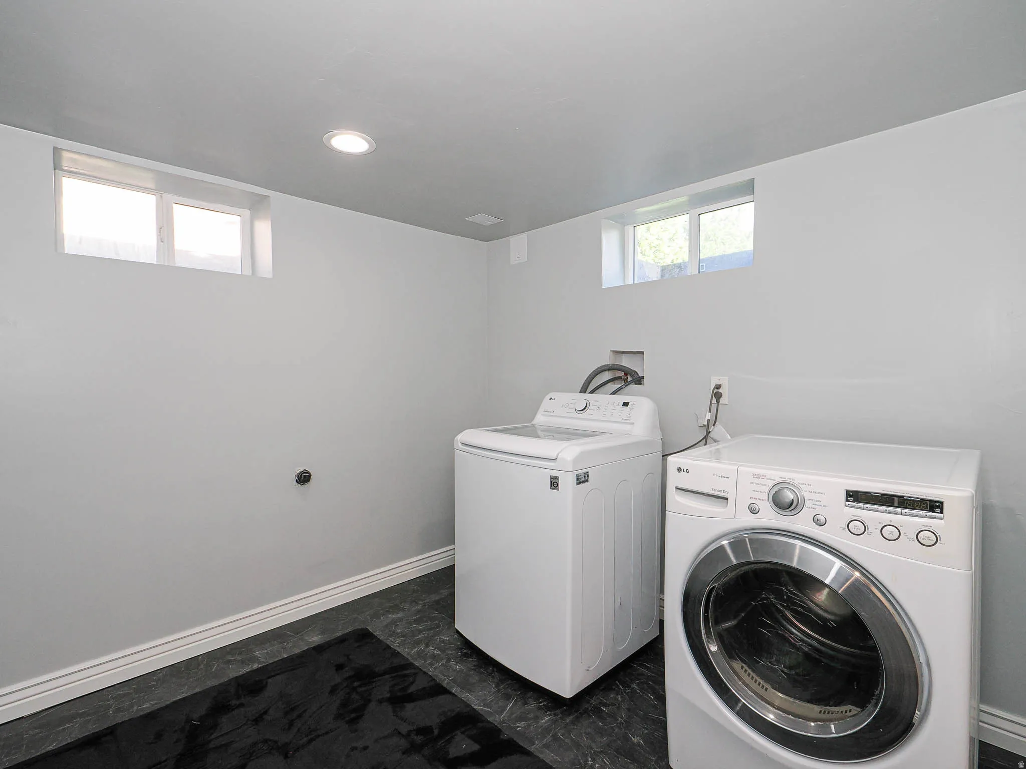 Laundry area featuring baseboards and separate washer and dryer