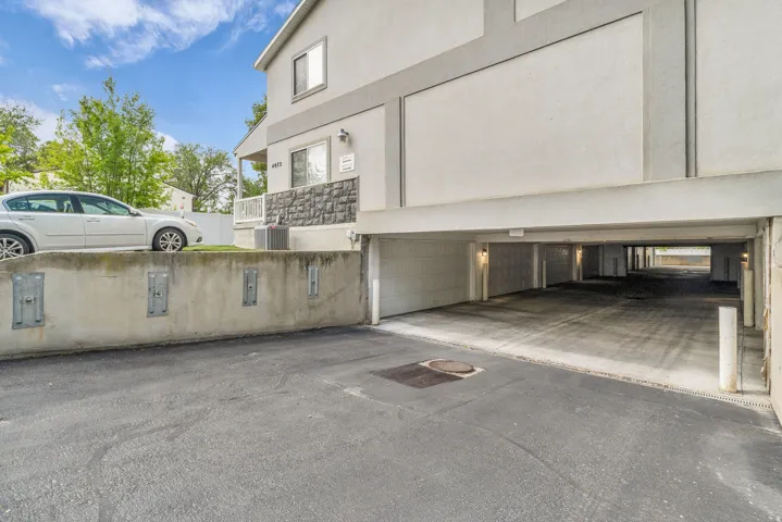 View of side of home featuring stucco siding and a garage
