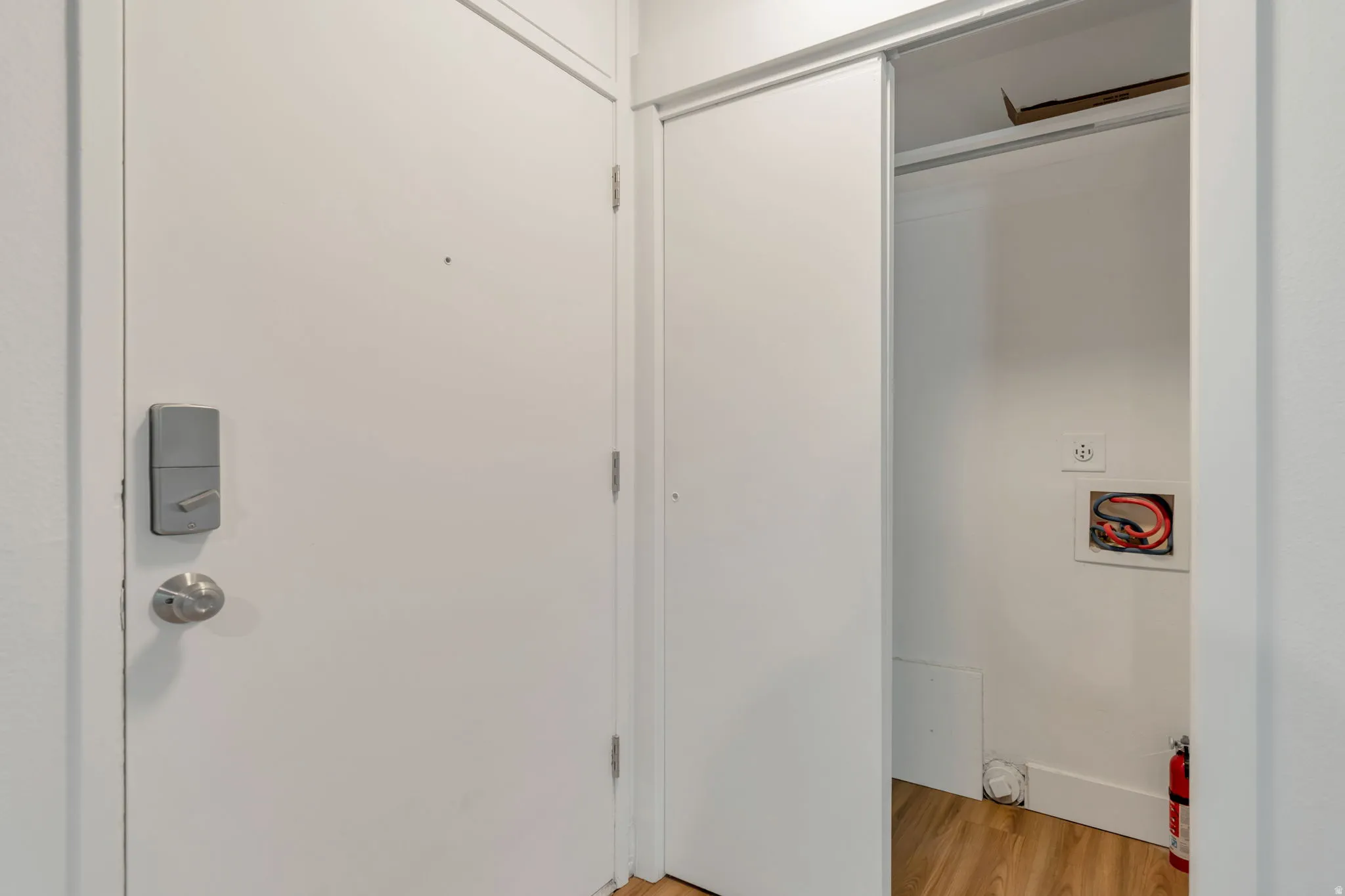 Laundry area featuring light wood-type flooring