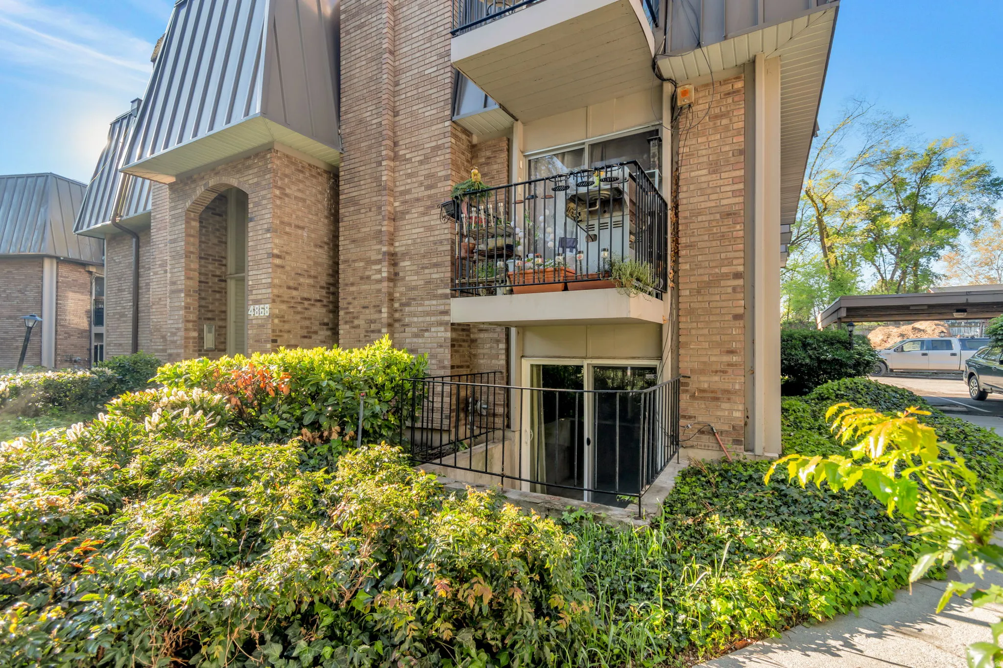 View of side of property featuring brick siding and a balcony