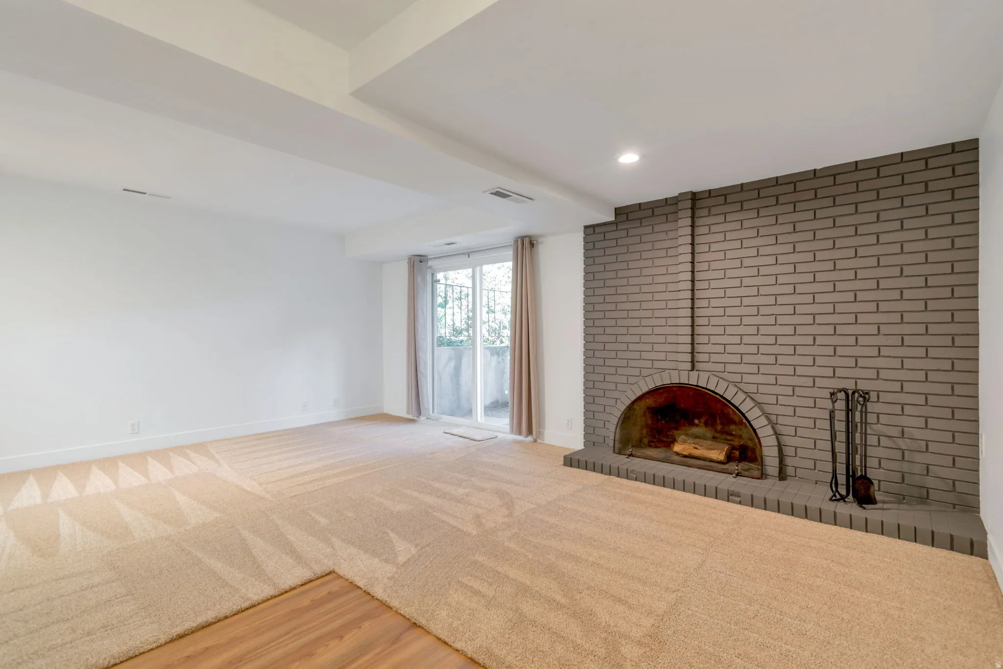 Unfurnished living room featuring a fireplace, recessed lighting, and light wood-type flooring