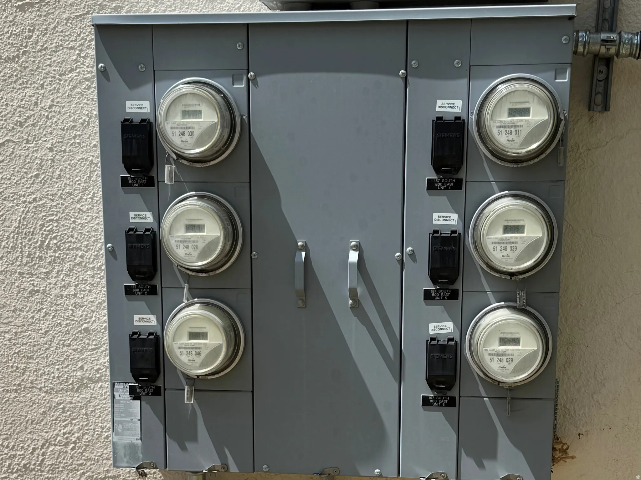 Exterior view of stucco siding and electric panel