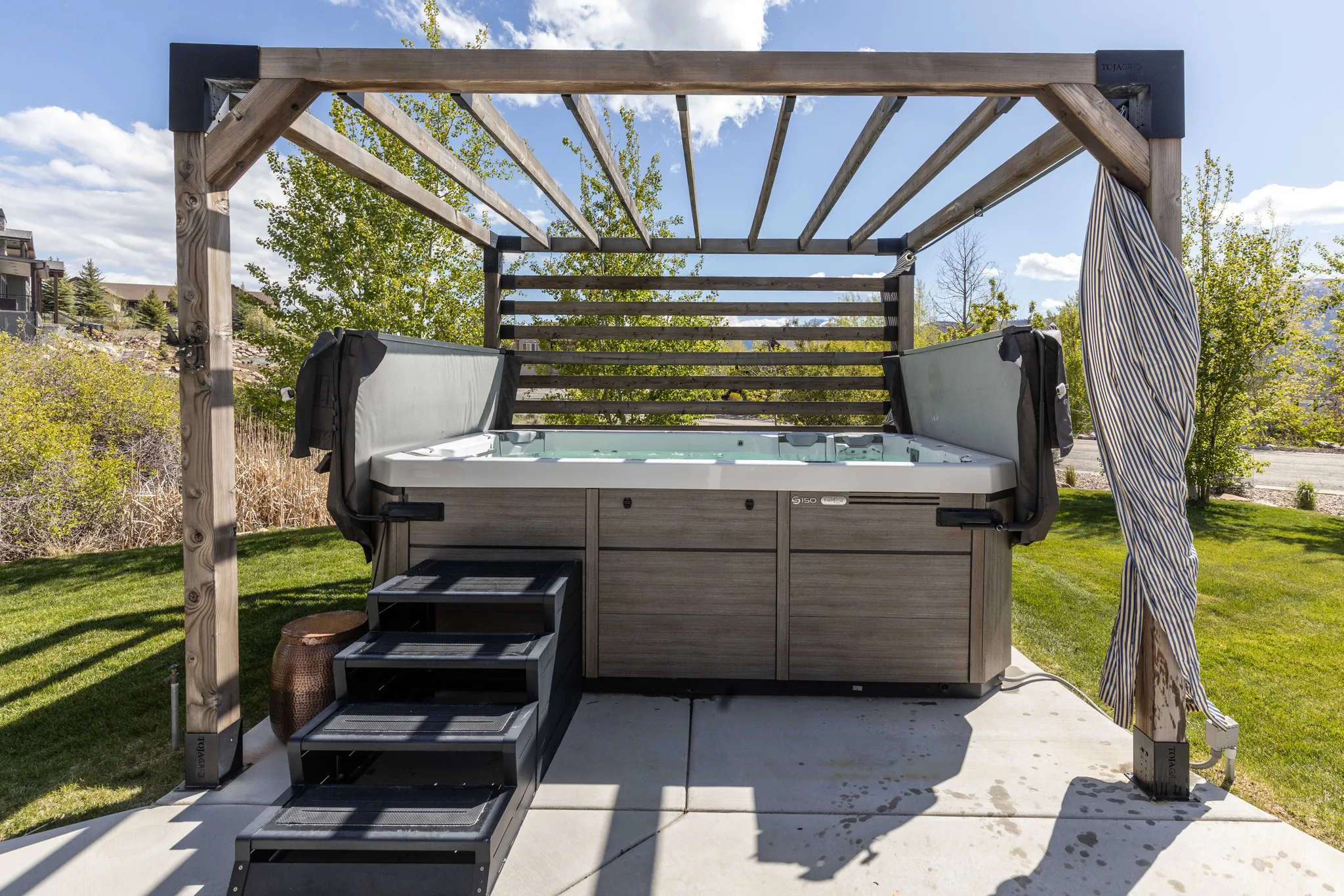 View of patio / terrace with a pergola and a hot tub