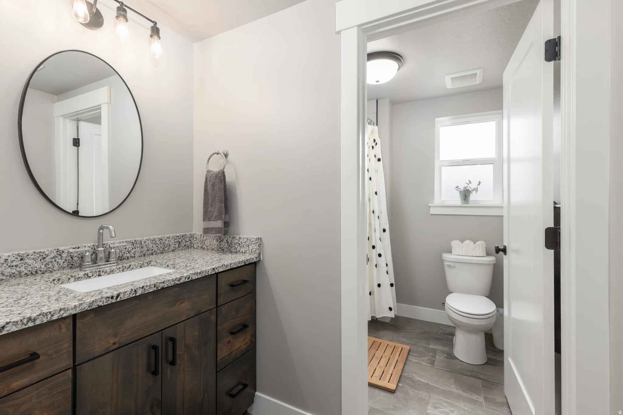 Bathroom featuring vanity and curtained shower