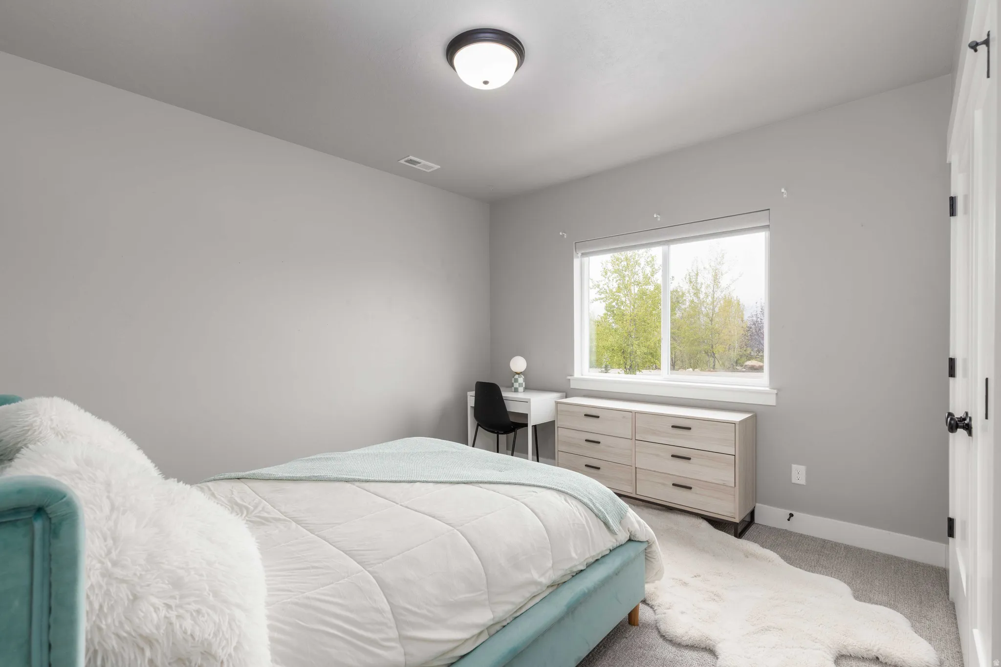 Carpeted bedroom featuring baseboards