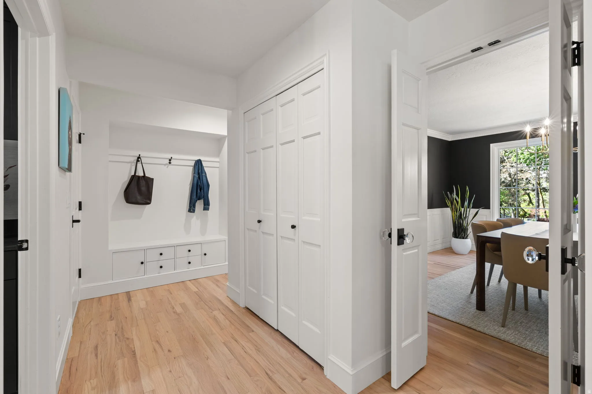 Mudroom with light wood-type flooring and baseboards
