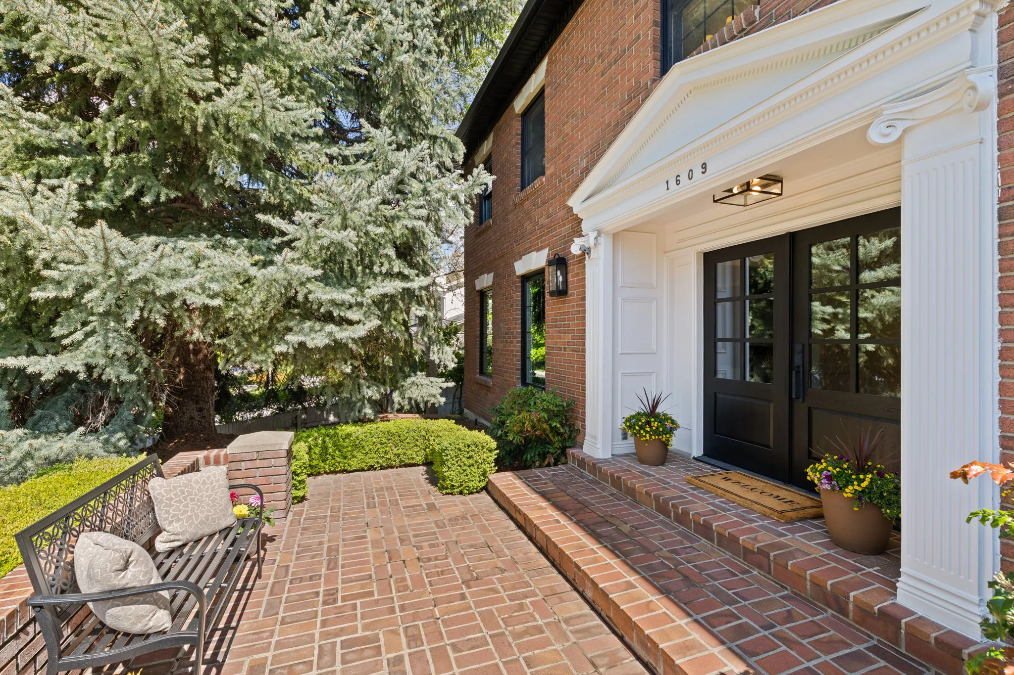 Entrance to property featuring brick siding and french doors
