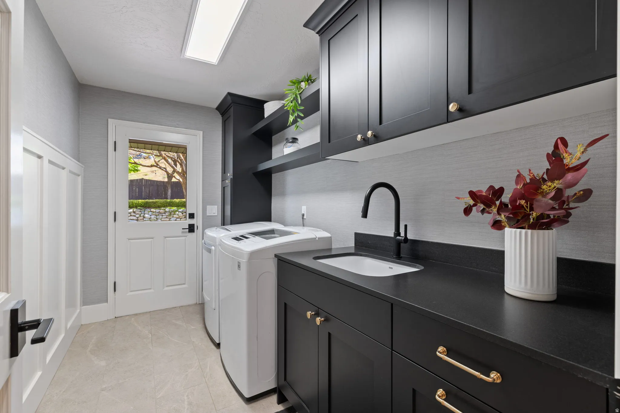Laundry area with cabinet space and washing machine and clothes dryer