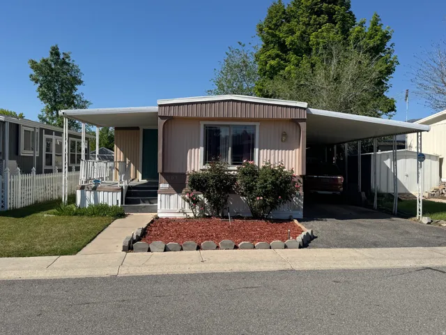 Siding exterior with covered front porch and carport
