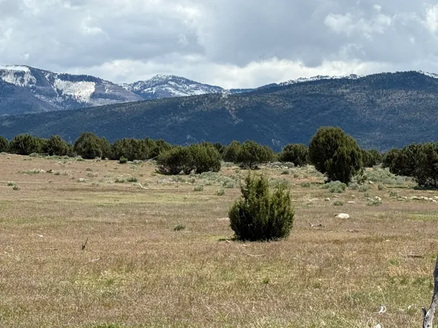 View of mountain background featuring rural landscape