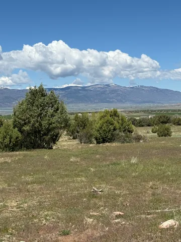 View of mountain backdrop featuring rural landscape
