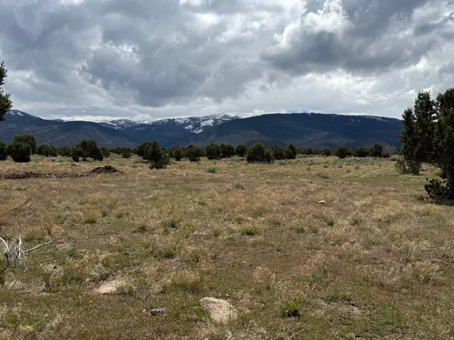 View of mountain backdrop with rural landscape