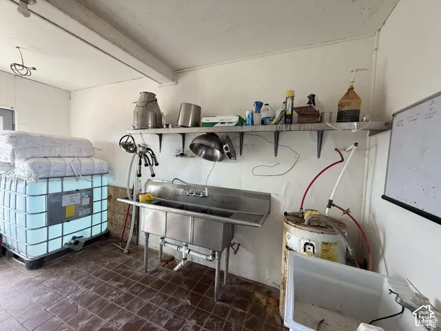 Misc room with a sink and tile patterned floors