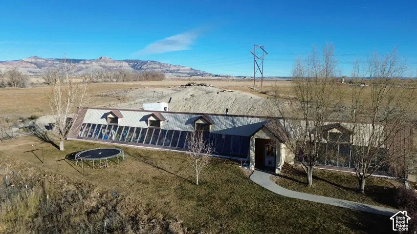 View of outbuilding featuring a trampoline, a rural view, and a mountain view