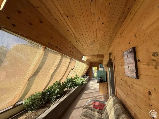 Corridor featuring wood walls and wooden ceiling