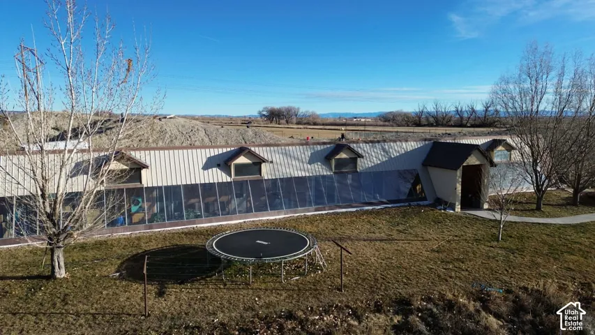 View of green lawn featuring a trampoline