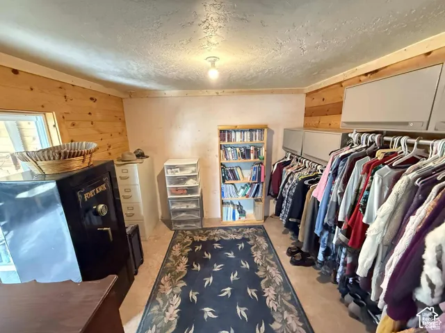 Walk in closet featuring light carpet