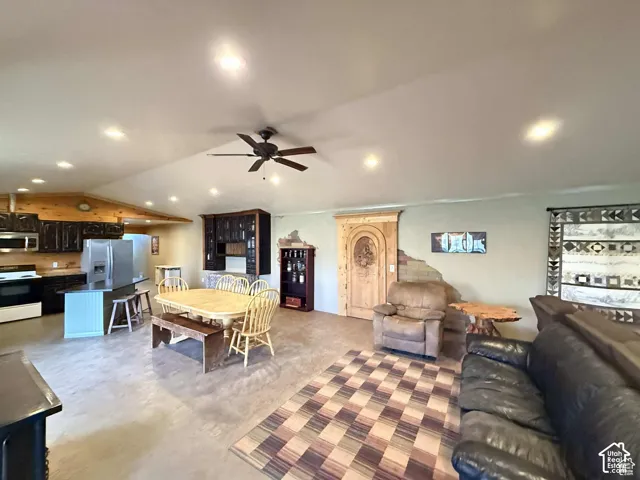 Dining room with a ceiling fan, recessed lighting, and lofted ceiling