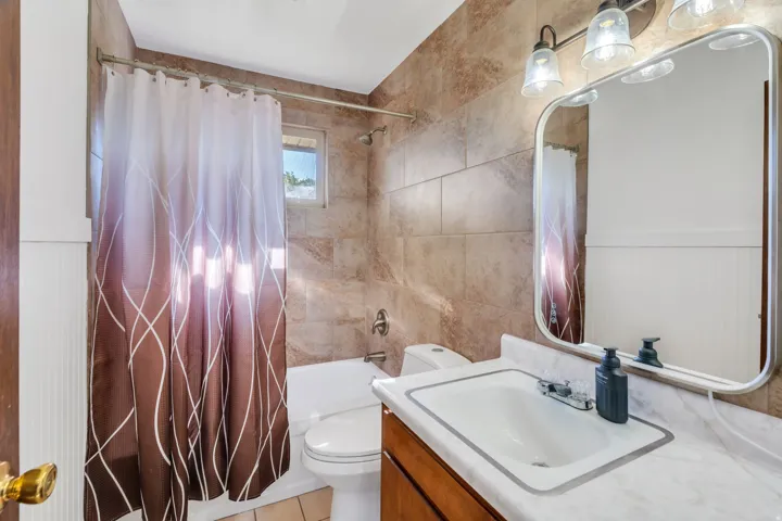 Bathroom with vanity and shower / tub combo