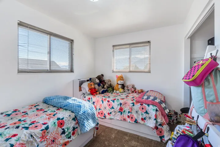 Bedroom with multiple windows and carpet flooring
