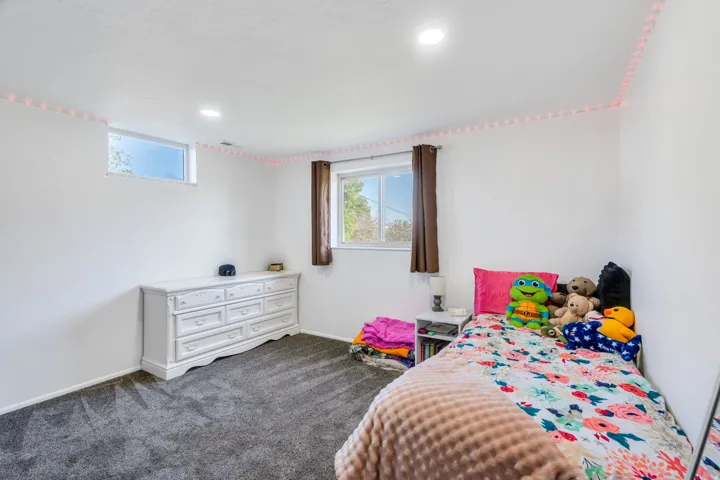 Bedroom featuring dark carpet and recessed lighting