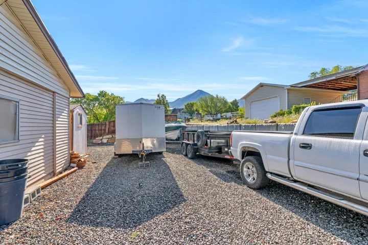 View of yard featuring a mountain view and a storage shed
