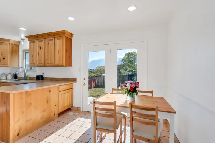 Kitchen with light countertops, light tile patterned floors, recessed lighting, light wood finish cabinetry, and a mountain view