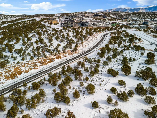 Snowy aerial view with a mountain view and a residential view