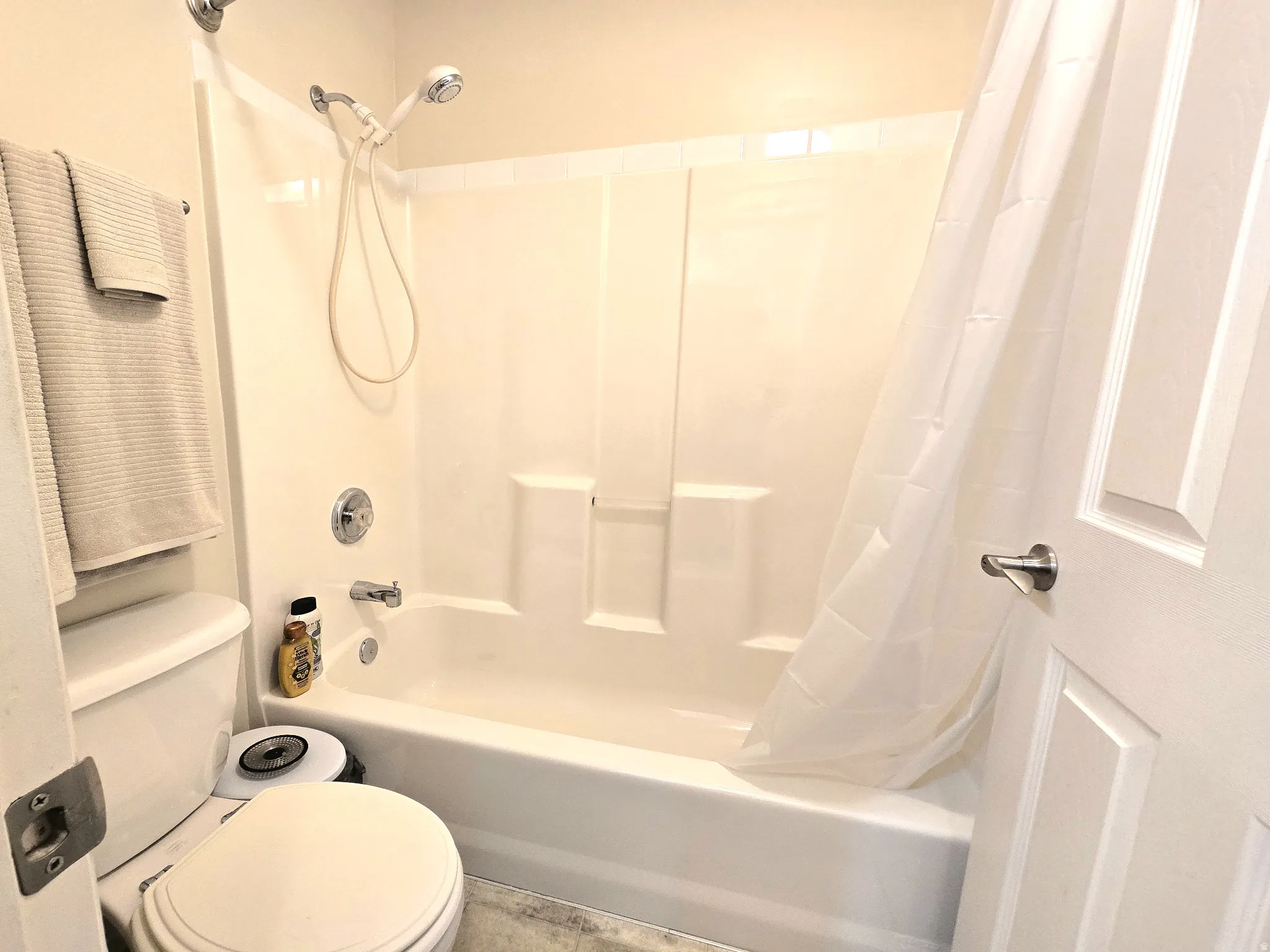 Full bathroom with toilet and shower / bath combo