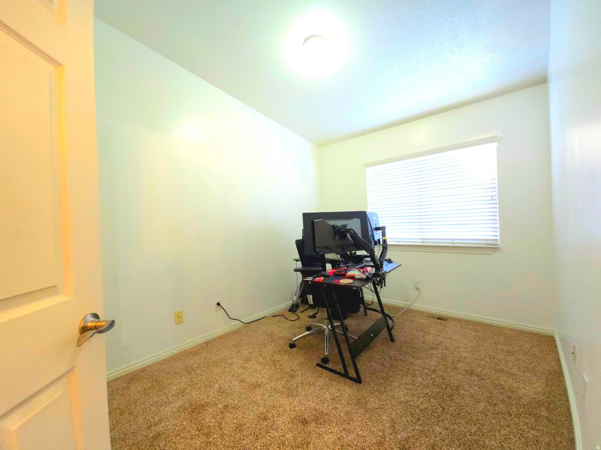 Office featuring carpet and vaulted ceiling