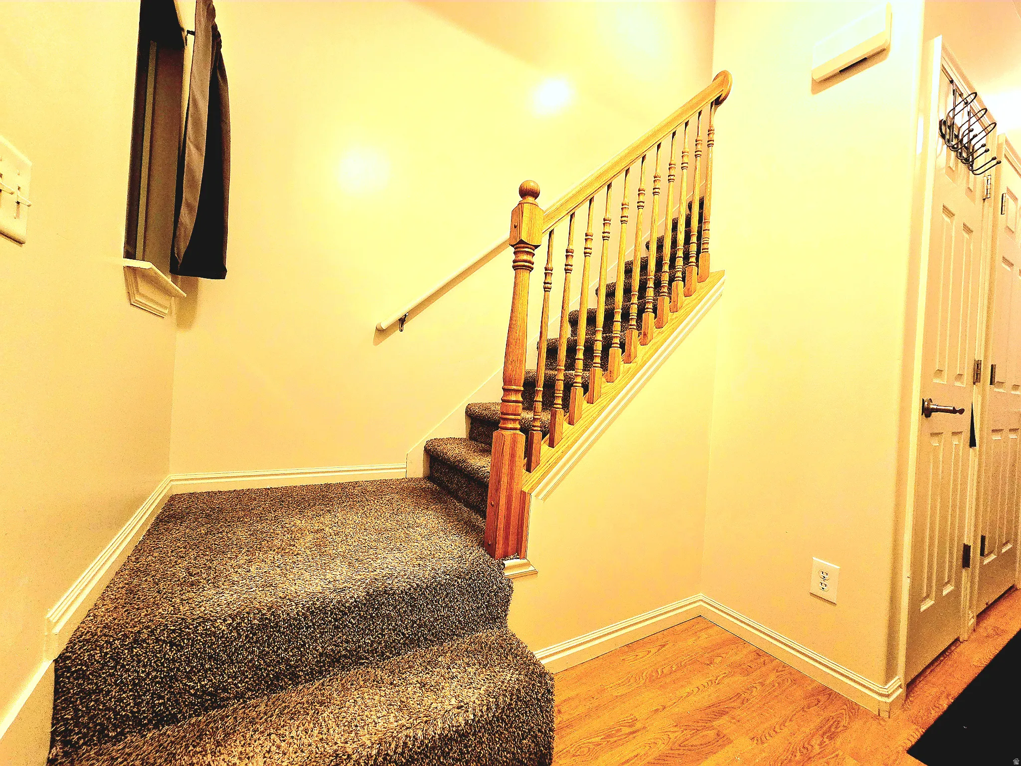 Stairway with baseboards and wood finished floors