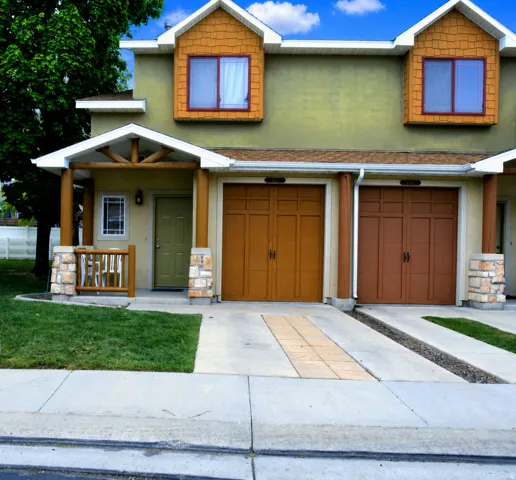 Craftsman house featuring stone siding, concrete driveway, and an attached garage