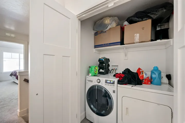 Laundry area featuring independent washer and dryer and carpet flooring